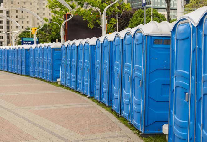 a row of portable restrooms set up for a large athletic event, allowing participants and spectators to easily take care of their needs in Burtonsville